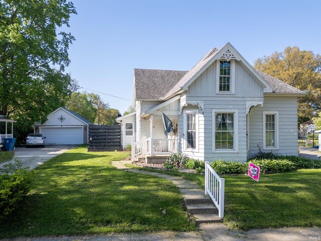 47 E Center St, Williamsport, IN 47993 - view of front facade featuring board and batten siding, a shingled roof, and a front lawn