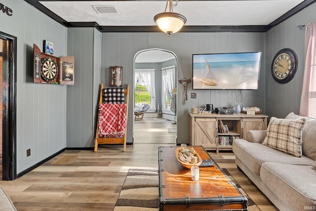 47 E Center St, Williamsport, IN 47993 - living room with crown molding, arched walkways, wood finished floors, and baseboards