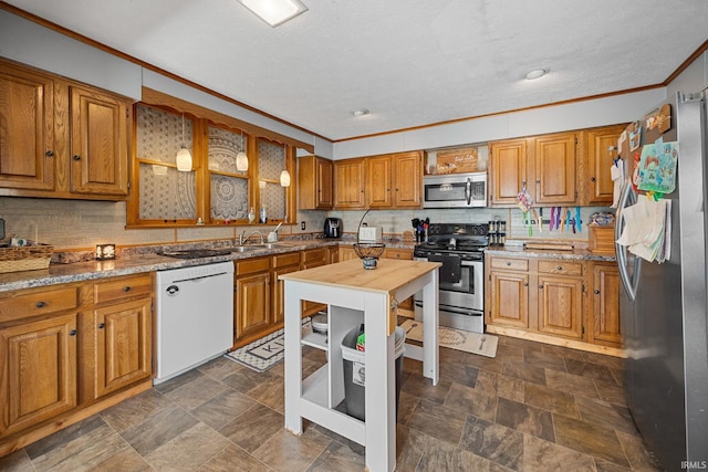 47 E Center St, Williamsport, IN 47993 - kitchen with appliances with stainless steel finishes, crown molding, brown cabinetry, decorative backsplash, and a sink