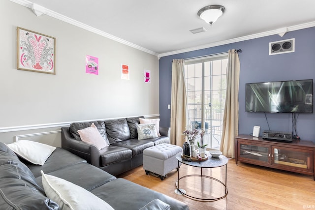 living area featuring crown molding and light wood-style flooring