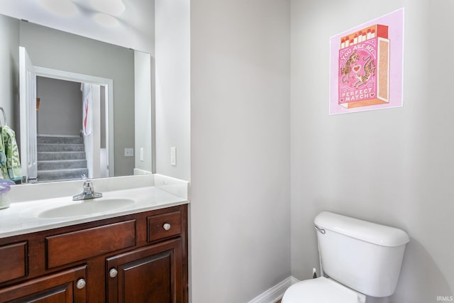 half bath featuring toilet and vanity