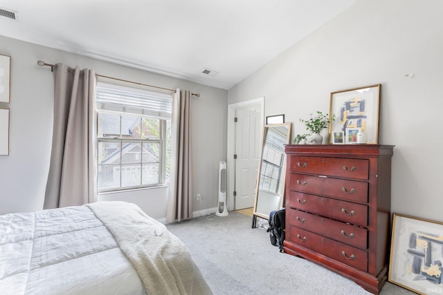 bedroom featuring carpet flooring, lofted ceiling, and baseboards