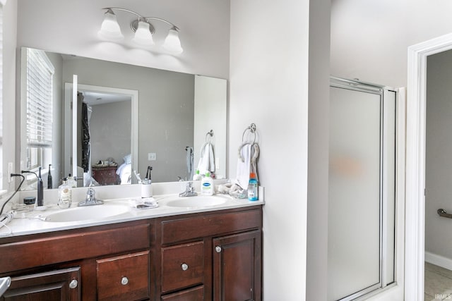 full bath featuring a stall shower, double vanity, and ensuite bath