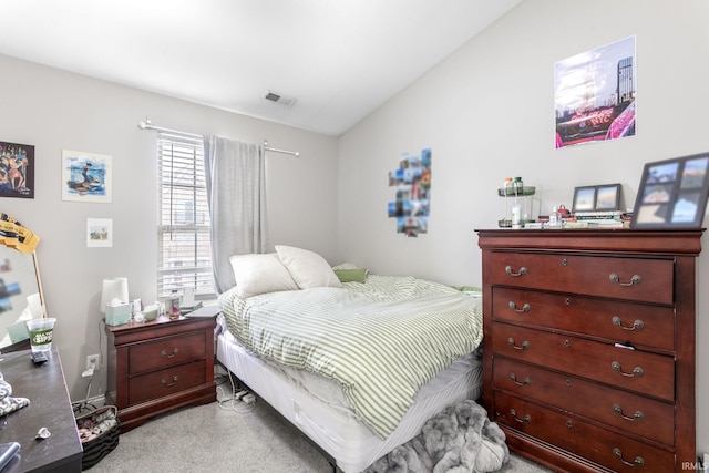 bedroom with lofted ceiling and light carpet