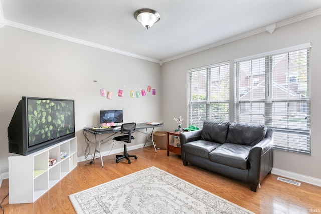 home office featuring crown molding, wood finished floors, and baseboards