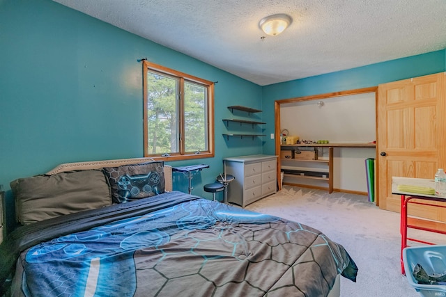 bedroom with light carpet and a textured ceiling