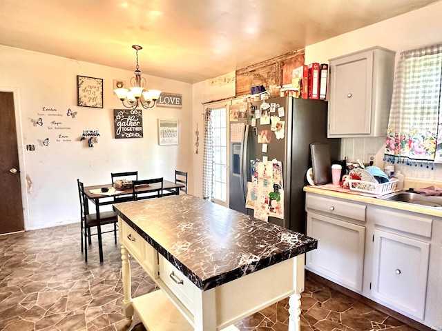 2796 Alexandria Ct, Lafayette, IN 47909 - kitchen with a chandelier, white cabinetry, pendant lighting, stainless steel fridge, and a sink