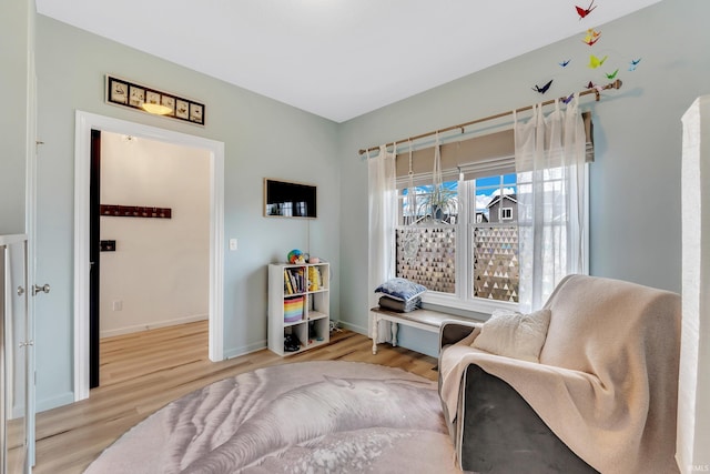 living area with wood finished floors and baseboards