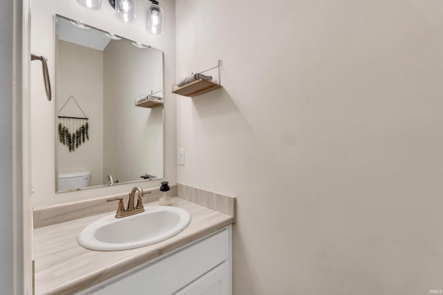 bathroom featuring toilet and vanity