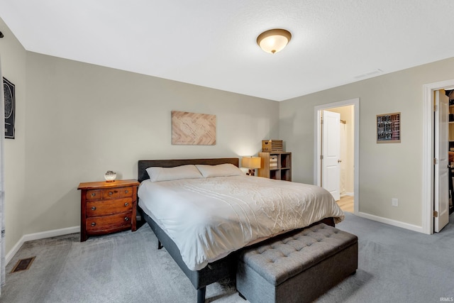 bedroom featuring carpet flooring, baseboards, and connected bathroom