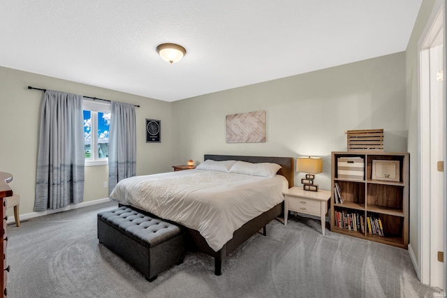 bedroom with carpet floors and baseboards