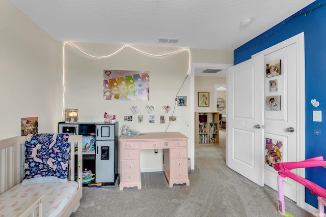 carpeted bedroom featuring a textured ceiling