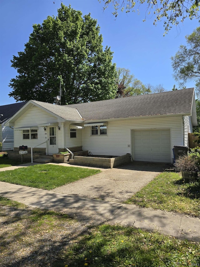304 N Main St, South Whitley, IN 46787 - ranch-style house featuring driveway, an attached garage, a front lawn, and roof with shingles