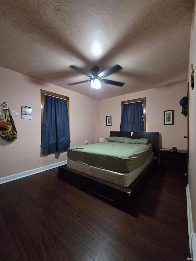 304 N Main St, South Whitley, IN 46787 - bedroom featuring wood finished floors, baseboards, a textured ceiling, and a ceiling fan