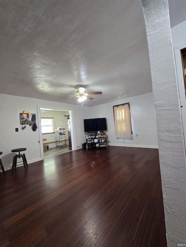 304 N Main St, South Whitley, IN 46787 - living area featuring ceiling fan, wood finished floors, a textured ceiling, and baseboards