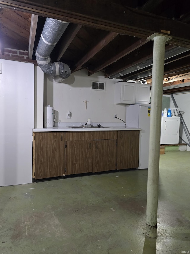 304 N Main St, South Whitley, IN 46787 - unfinished basement featuring washer / clothes dryer, freestanding refrigerator, and a sink