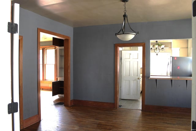 404 S Peters St, Garrett, IN 46738 - unfurnished dining area featuring hardwood / wood-style flooring and baseboards