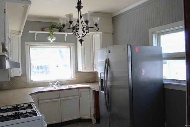 404 S Peters St, Garrett, IN 46738 - kitchen featuring stainless steel fridge with ice dispenser, a sink, tasteful backsplash, white range with gas stovetop, and a chandelier
