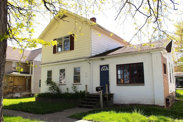 404 S Peters St, Garrett, IN 46738 - view of front facade featuring a chimney and brick siding