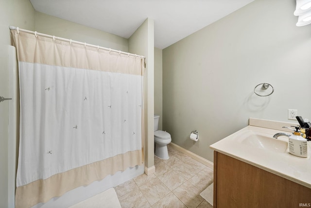 51025 Bellcrest Cir, Granger, IN 46530 - full bathroom featuring toilet, a shower with shower curtain, vanity, and baseboards