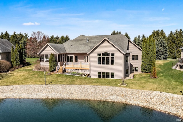 51025 Bellcrest Cir, Granger, IN 46530 - back of house featuring a lawn, a deck with water view, and roof with shingles