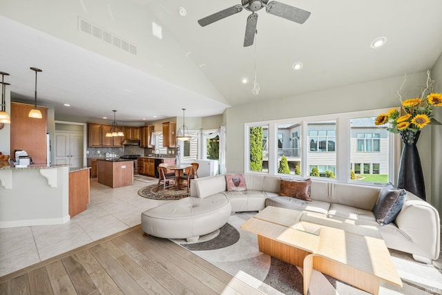 51025 Bellcrest Cir, Granger, IN 46530 - living area with light wood-style flooring, lofted ceiling, ceiling fan, and recessed lighting