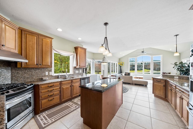 51025 Bellcrest Cir, Granger, IN 46530 - kitchen featuring stainless steel appliances, a sink, backsplash, brown cabinetry, and vaulted ceiling
