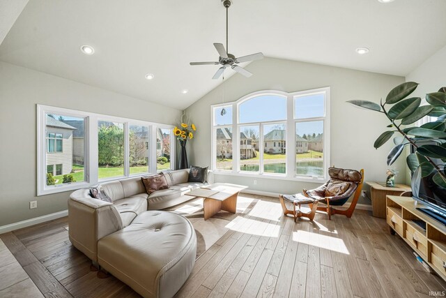 51025 Bellcrest Cir, Granger, IN 46530 - living area with healthy amount of natural light, hardwood / wood-style flooring, a ceiling fan, baseboards, and lofted ceiling