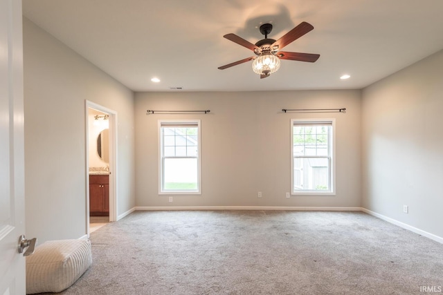 unfurnished bedroom with multiple windows, carpet floors, baseboards, and recessed lighting
