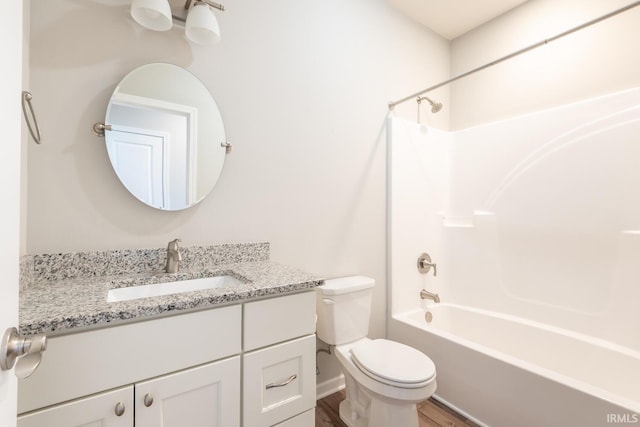 full bathroom with toilet, vanity, wood finished floors, and tub / shower combination