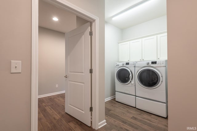 laundry room with washing machine and clothes dryer, dark wood-type flooring, baseboards, and recessed lighting