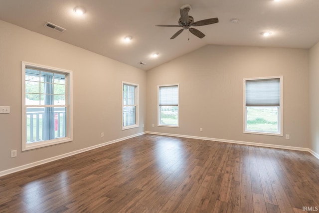 empty room featuring dark wood-style floors, a ceiling fan, lofted ceiling, and baseboards