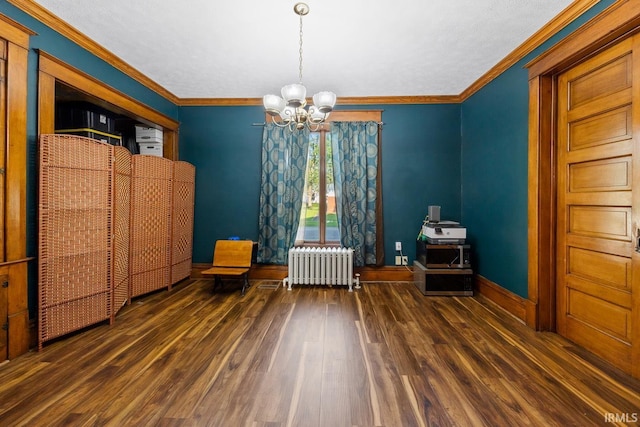 dining area with radiator, a chandelier, wood finished floors, baseboards, and ornamental molding
