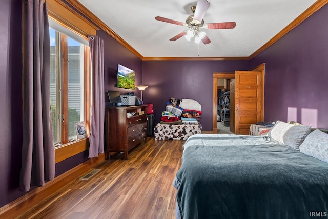 bedroom featuring dark wood-style flooring, ornamental molding, and ceiling fan