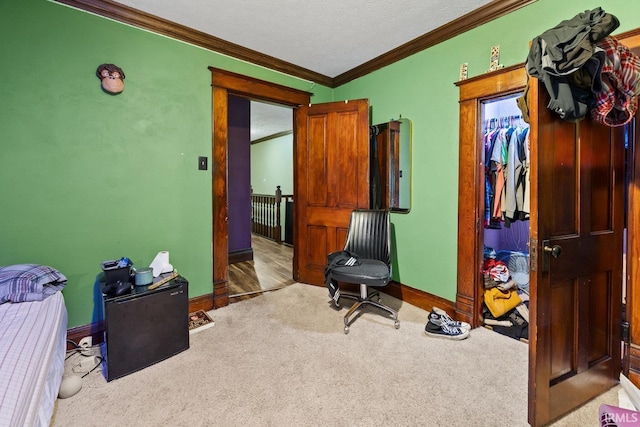 carpeted bedroom featuring ornamental molding and baseboards