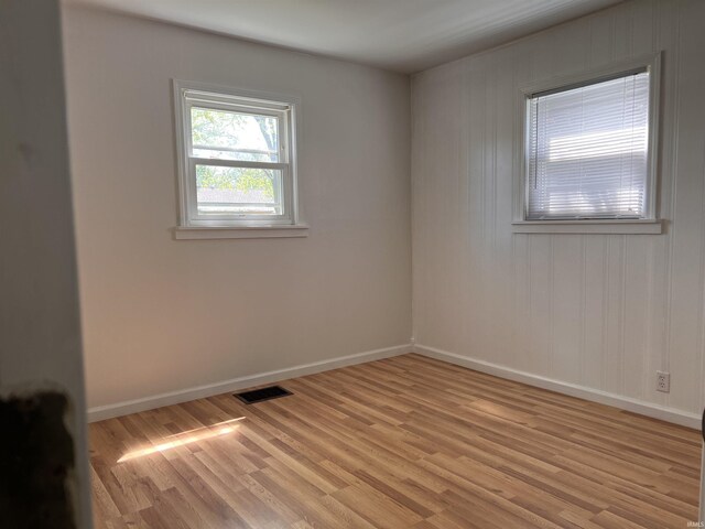 2211 E 19th St, Muncie, IN 47302 - unfurnished room with light wood finished floors and baseboards