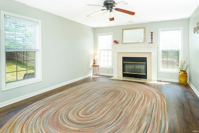 1017 S Carleton Ct, Bloomington, IN 47401 - living room featuring wood finished floors, baseboards, ceiling fan, and a fireplace with flush hearth