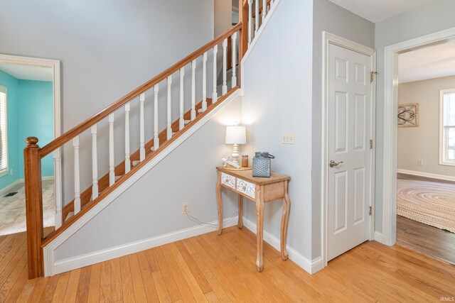 1017 S Carleton Ct, Bloomington, IN 47401 - stairs with hardwood / wood-style flooring and baseboards
