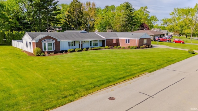 119 Highland Dr, Wabash, IN 46992 - ranch-style house featuring concrete driveway, a front yard, and brick siding