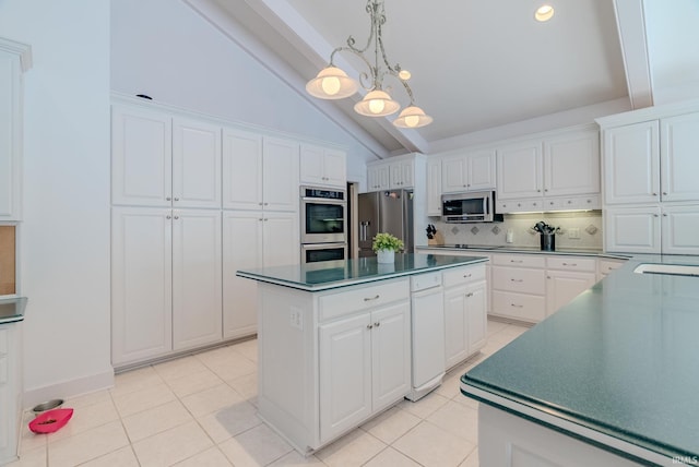 119 Highland Dr, Wabash, IN 46992 - kitchen with appliances with stainless steel finishes, decorative backsplash, dark countertops, white cabinetry, and a center island