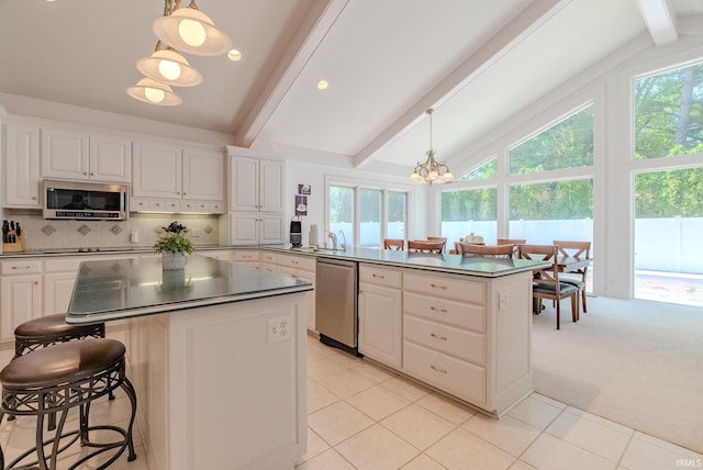 119 Highland Dr, Wabash, IN 46992 - kitchen featuring stainless steel appliances, dark countertops, beamed ceiling, a chandelier, and white cabinets