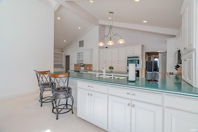 119 Highland Dr, Wabash, IN 46992 - kitchen with a sink, stainless steel appliances, beam ceiling, dark countertops, and white cabinetry