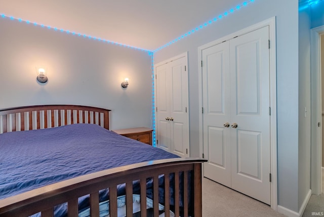 119 Highland Dr, Wabash, IN 46992 - bedroom featuring light carpet, multiple closets, and baseboards