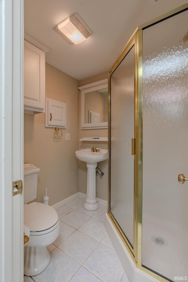 119 Highland Dr, Wabash, IN 46992 - bathroom featuring a stall shower, tile patterned floors, toilet, and baseboards