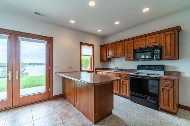 20 Lane 650c Snow Lk, Fremont, IN 46737 - kitchen featuring black appliances, a peninsula, recessed lighting, brown cabinets, and baseboards