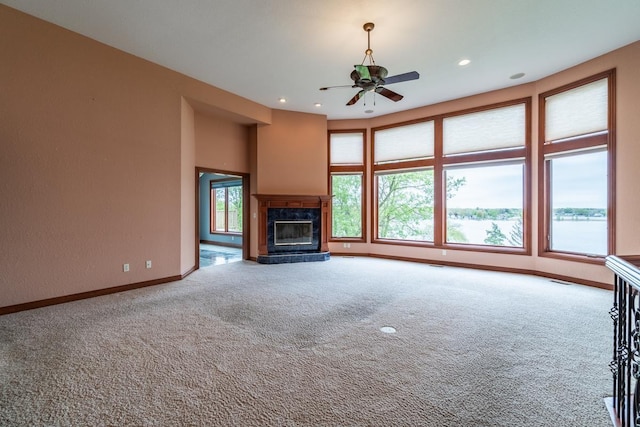 20 Lane 650c Snow Lk, Fremont, IN 46737 - unfurnished living room with carpet flooring, ceiling fan, baseboards, a fireplace, and recessed lighting