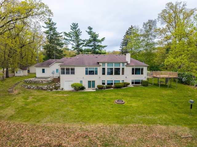 20 Lane 650c Snow Lk, Fremont, IN 46737 - rear view of house with a chimney, a fire pit, a deck, and a lawn