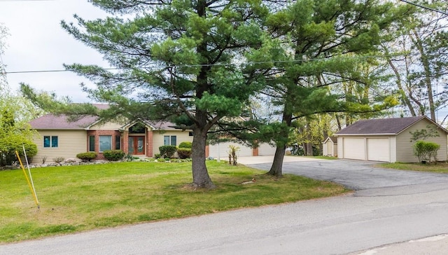 20 Lane 650c Snow Lk, Fremont, IN 46737 - ranch-style home featuring a detached garage, an outdoor structure, and a front lawn