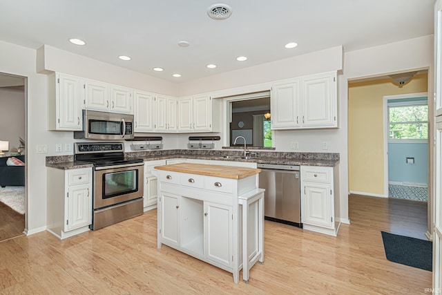 5002 Buffalo Ct, Fort Wayne, IN 46804 - kitchen featuring appliances with stainless steel finishes, wood counters, a sink, light wood finished floors, and recessed lighting