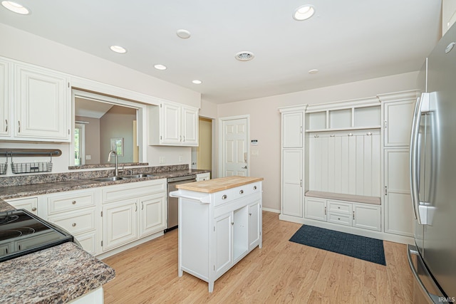 5002 Buffalo Ct, Fort Wayne, IN 46804 - kitchen featuring appliances with stainless steel finishes, a sink, light wood finished floors, recessed lighting, and wood counters
